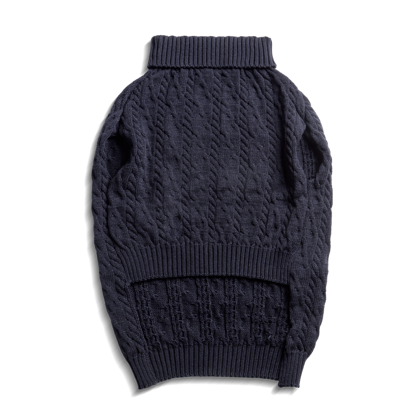 The Shinola Cable Knit Dog Sweater in ivory is laid flat on a white background. This dog turtleneck sweater features ribbed cuffs, hem, and collar with a textured cable knit pattern throughout.