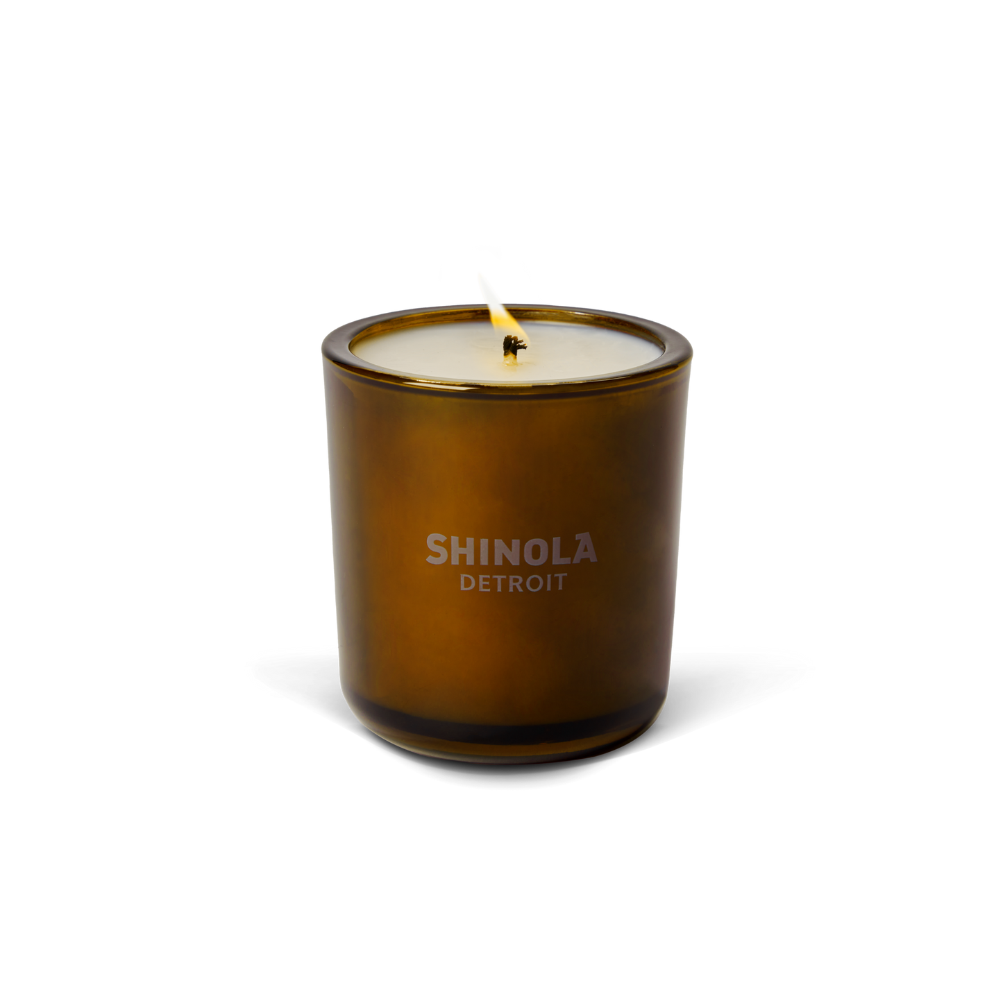 The Shinola Hotel 8oz Scented Candle, made from coconut soy wax in a brown recycled glass vessel with "Shinola Detroit" printed on the front, is displayed against a plain white background.