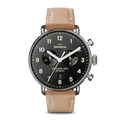 The Shinola Canfield Chronograph Watch - Black features a black dial with white numerals, two subdials, a date window, tan leather strap, silver top-loaded case, and “Shinola” and “Detroit” on the face.