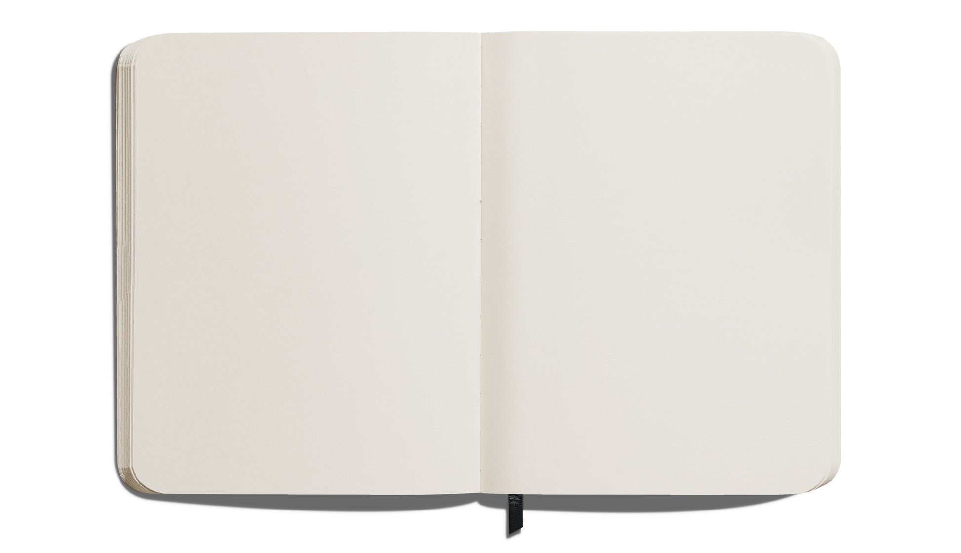 The Shinola Large Hard Plain Journal – Stone is shown from above, featuring acid-free white pages, rounded corners, a black ribbon bookmark, and a durable design that combines style and function.