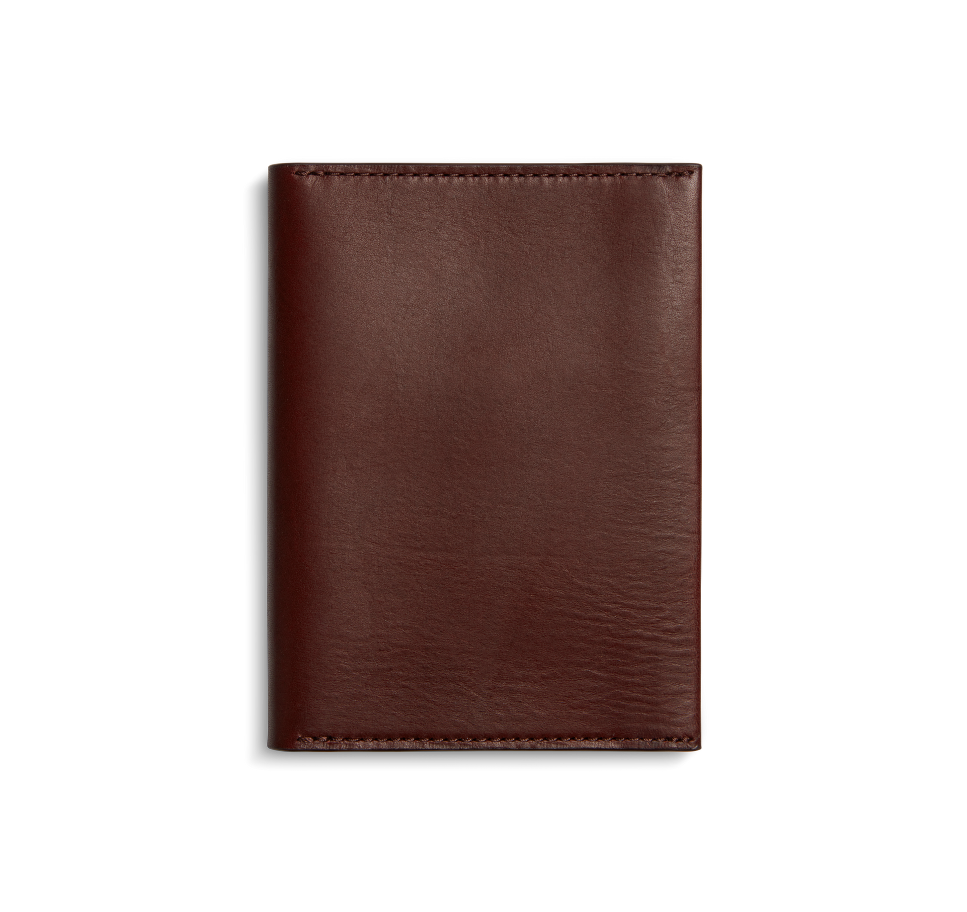 The Shinola Passport Holder - Merlot, a closed rectangular wallet, is crafted from Italian Vachetta leather and displayed against a plain white background.