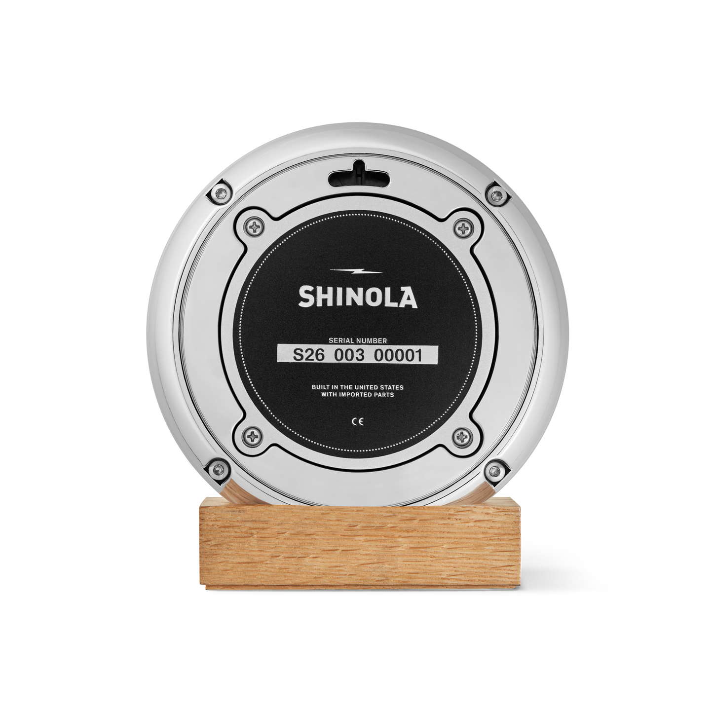 A round, silver Shinola 6" Runwell Clock with a blue faceplate, mounted on a rectangular wooden base, stands out against a white background—an elegant nod to University of Michigan’s wolverine blue heritage.