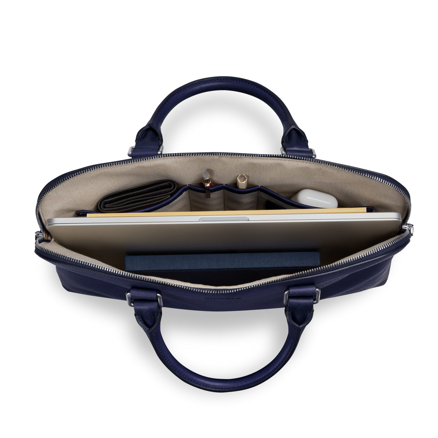 Top-down view of the Shinola Portfolio Briefcase - Lake in navy European grain leather, with a laptop, notebook, wallet, pens, and a small round accessory neatly stored in dedicated compartments.