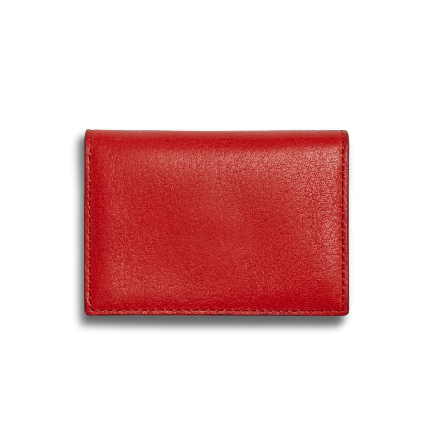 A closed, rectangular Birdy Accordion Card Holder - Tomato by Shinola, made of natural leather with visible stitching and multiple card pockets, is shown against a plain white background.