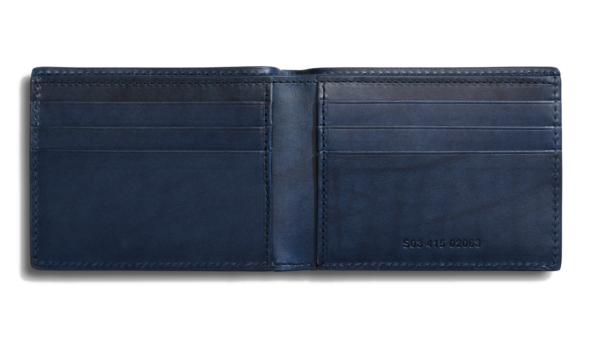 The Shinola Slim Bifold Wallet - Navy is open, revealing card slots on both sides, a bill pocket, and RFID protection. A small set of numbers is embossed on the inside lower right panel.