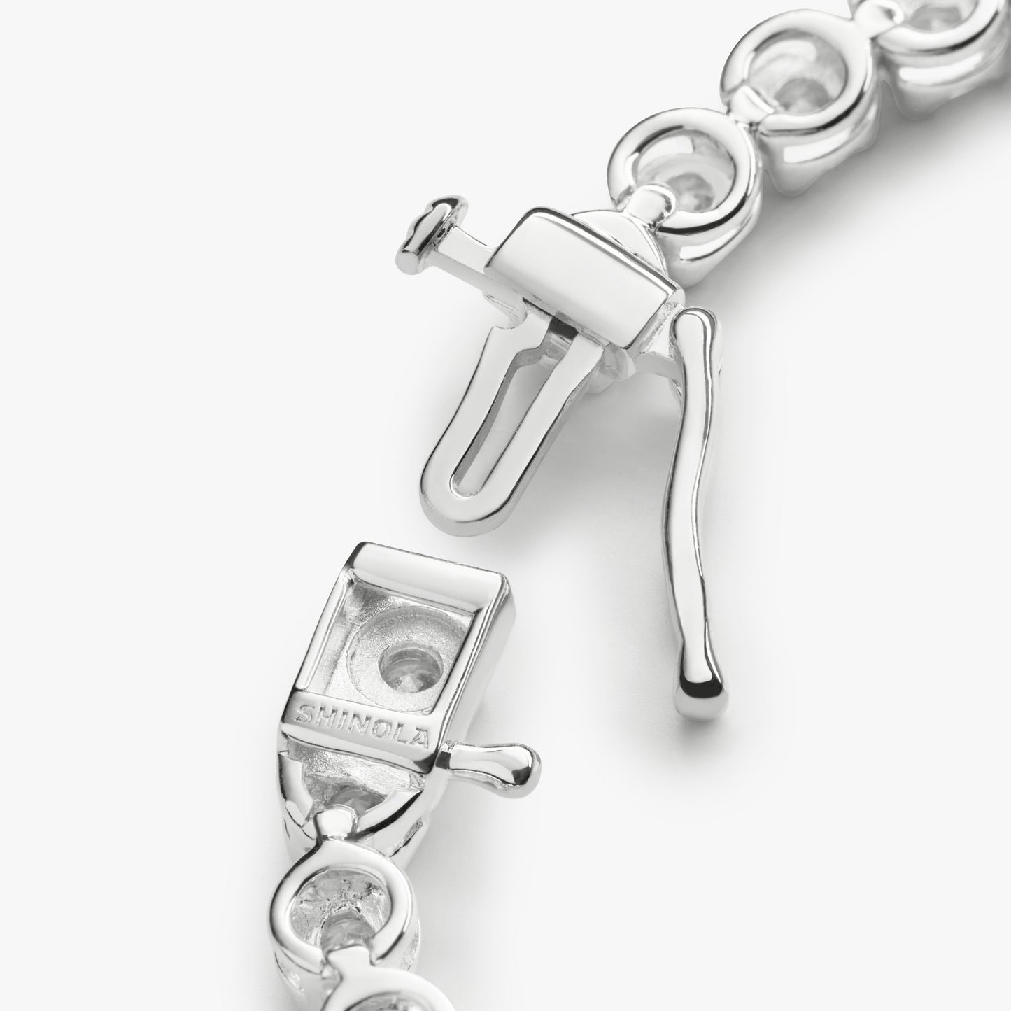Close-up of the clasp on the Shinola 4 Carat 7" Diamond Tennis Bracelet in white gold, featuring intricate links and a “S 1MM CL” engraving on the box and tongue mechanism.