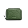 The Pocket Small Zip Around Wallet - Evergreen by Shinola is a compact, green grain leather wallet with a textured finish and “SHINOLA” embossed on the front, displayed against a plain white background.
