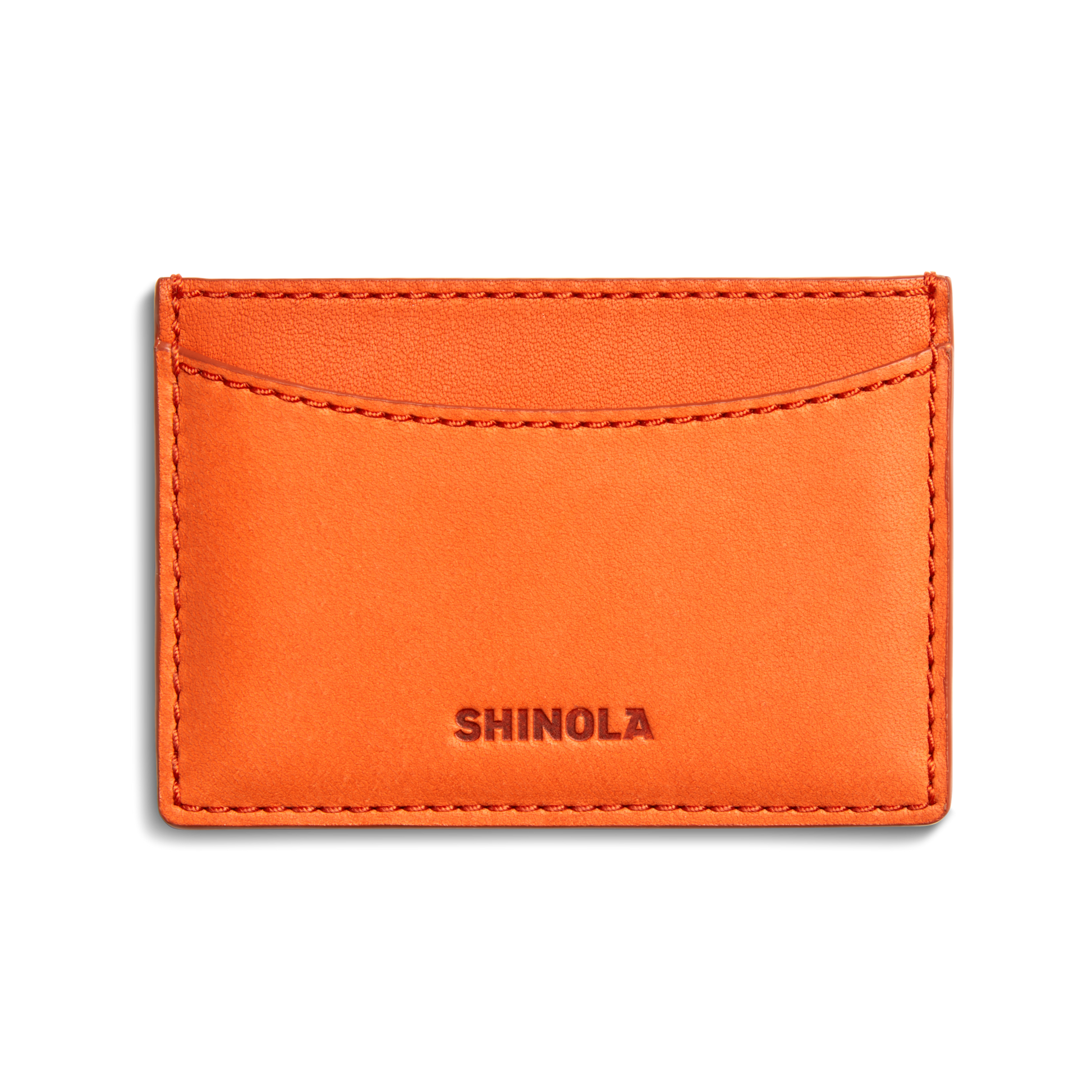 A tangerine Leather 3 Pocket Card Case by Shinola featuring visible stitching, three pockets, and the Shinola name embossed at the bottom center.