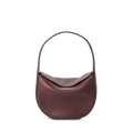 The Shinola Small Shoulder Bag - Merlot features natural grain leather, a curved silhouette, single wide handle, and pebbled texture. Subtle gold branding highlights its premium craftsmanship against a plain white background.