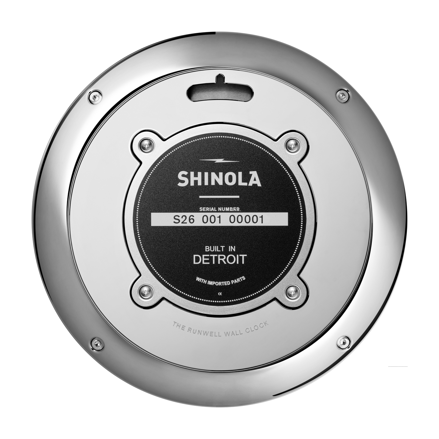 A close-up of the back of a Shinola 14" Runwell Clock - Blue shows a round metallic case with a black center label that reads "Shinola, Built in Detroit, With Imported Parts.