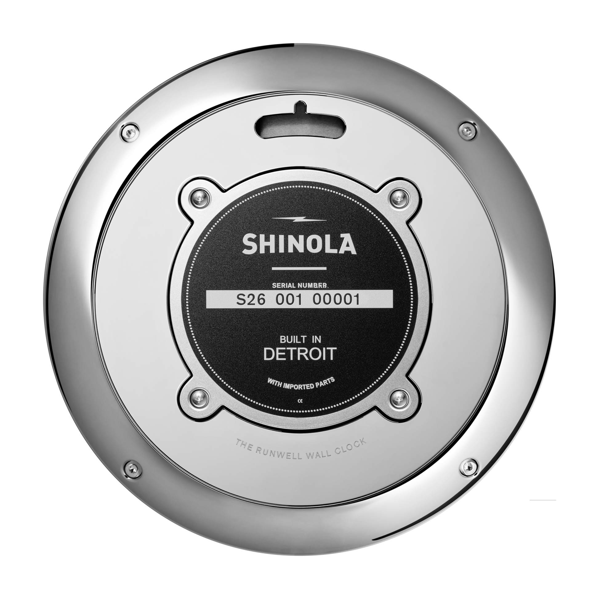 A close-up of the back of a Shinola 14" Runwell Clock - Blue shows a round metallic case with a black center label that reads "Shinola, Built in Detroit, With Imported Parts.