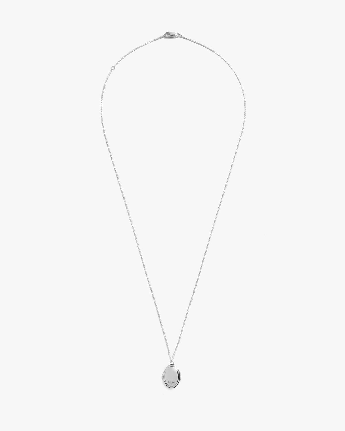 The Shinola Heirloom Petite Locket Necklace features a small oval sterling silver pendant on a fine chain, shown against a plain white background.