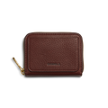The Shinola Pocket Small Zip Around Wallet in Merlot features textured brown leather, a gold zipper pull, and SHINOLA embossed on the front, displayed against a white background.