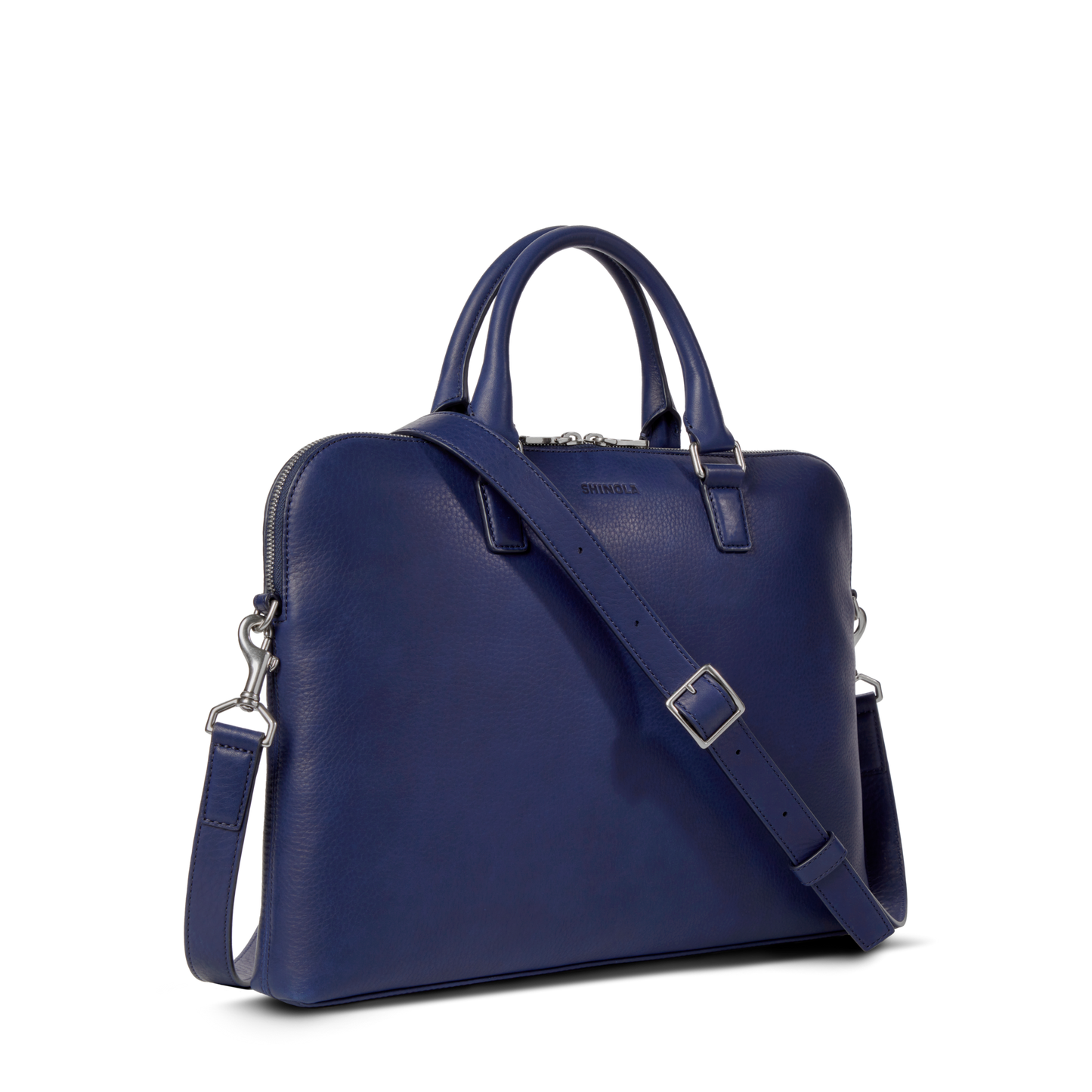 The Shinola Portfolio Briefcase - Lake is a blue slim laptop briefcase made from European grain leather with dual handles, a detachable shoulder strap, and silver hardware, shown against a plain white background.