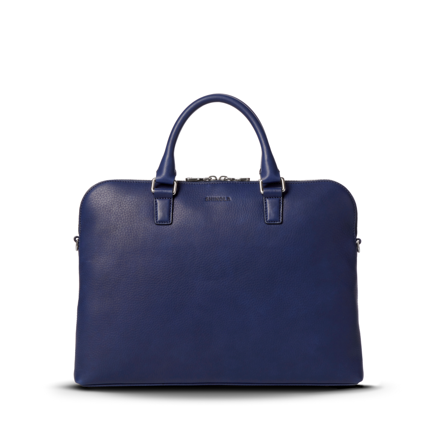 The Shinola Portfolio Briefcase - Lake is a navy slim laptop briefcase in European grain leather, with two handles, a silver zipper, and subtle logo text near the top center, shown against a plain white background.