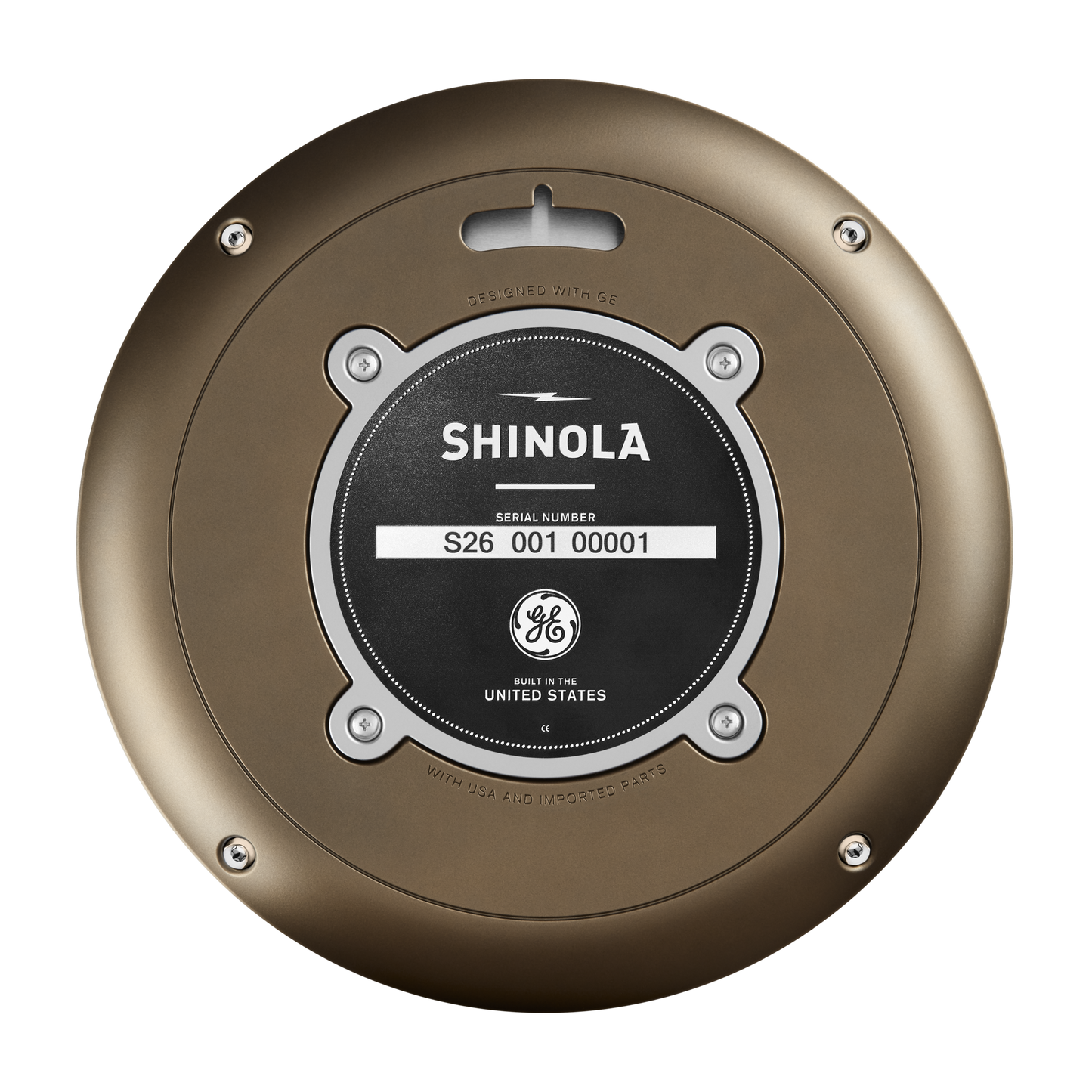 A close-up of a round metallic plate labeled Shinola with a serial number S26 001 00001, seen on the 14" Runwell Clock - Black. The plate features a GE logo and the phrase "Built in the United States.