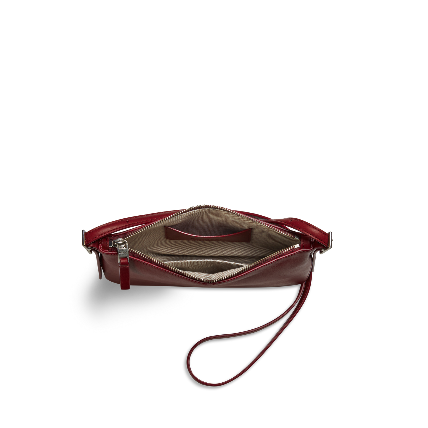 The Shinola Small Bixby Crossbody - Ruby is a compact red natural leather purse with a zippered top, beige lining, inner card pocket, and one-sided wrist strap. Photographed from above on a white background, it's perfect for everyday use.
