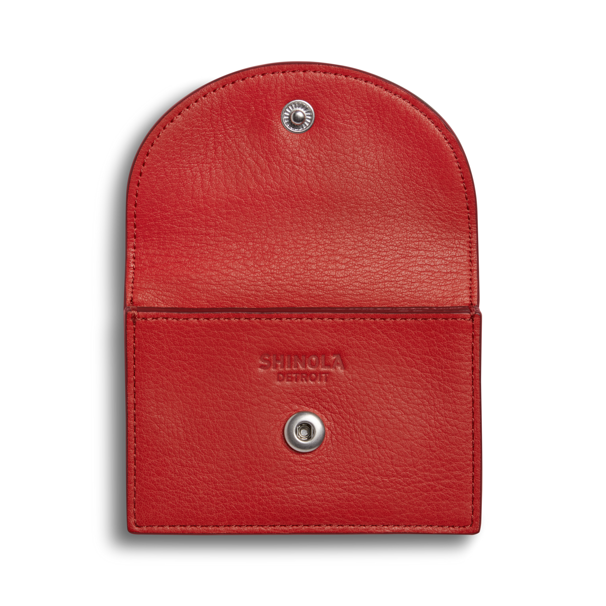 The Shinola Birdy Accordion Card Holder - Tomato is a red leather pouch with a flap, snap button closure, and inner card pockets. "Shinola Detroit" is stamped inside. It's photographed against a plain white background.