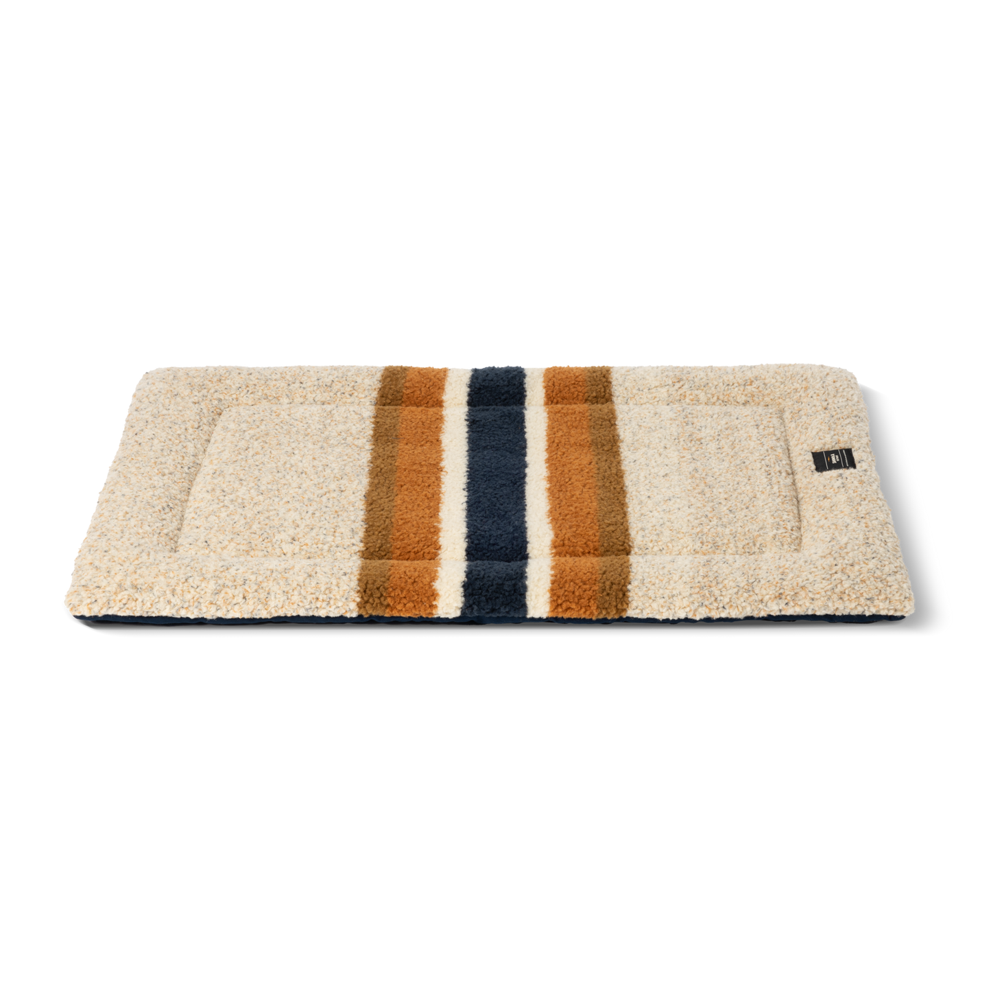 The Shinola Crate Comfort Mat - Stripe Brown is a rectangular, beige, textured dog crate cushion with two brown and one navy stripe down the center. It doubles as a machine washable dog bed for easy cleaning.