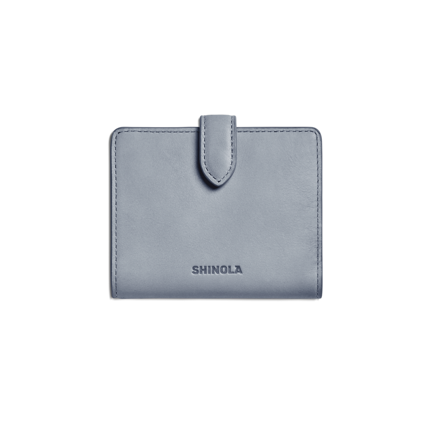 A closed Small Snap Wallet - Mist by Shinola, featuring a light blue color and tab closure with the brand name embossed on the front, is shown against a plain white background.