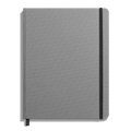 The Shinola Large Hard Ruled Journal in Stone features a closed gray linen cover, a black elastic band along the right edge, and a black ribbon bookmark against a white background.