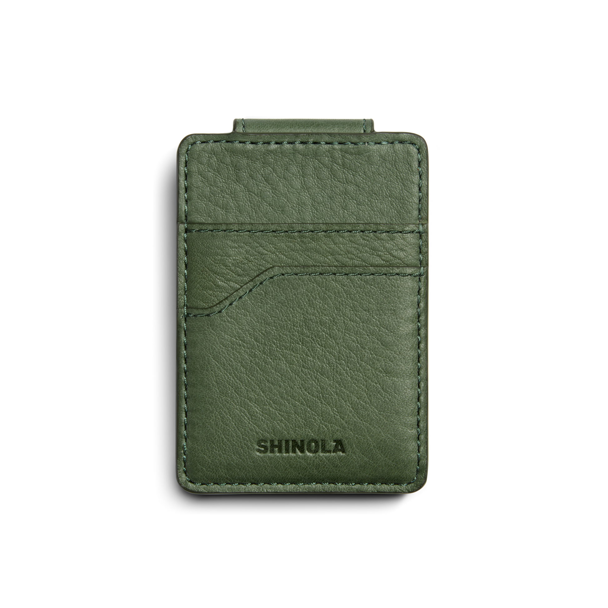 The Magnetic Money Clip Card Holder - Evergreen by Shinola is a green leather card holder with visible stitching, a front curved pocket, RFID-blocking technology, and an embossed logo at the bottom. Shown on a white background.