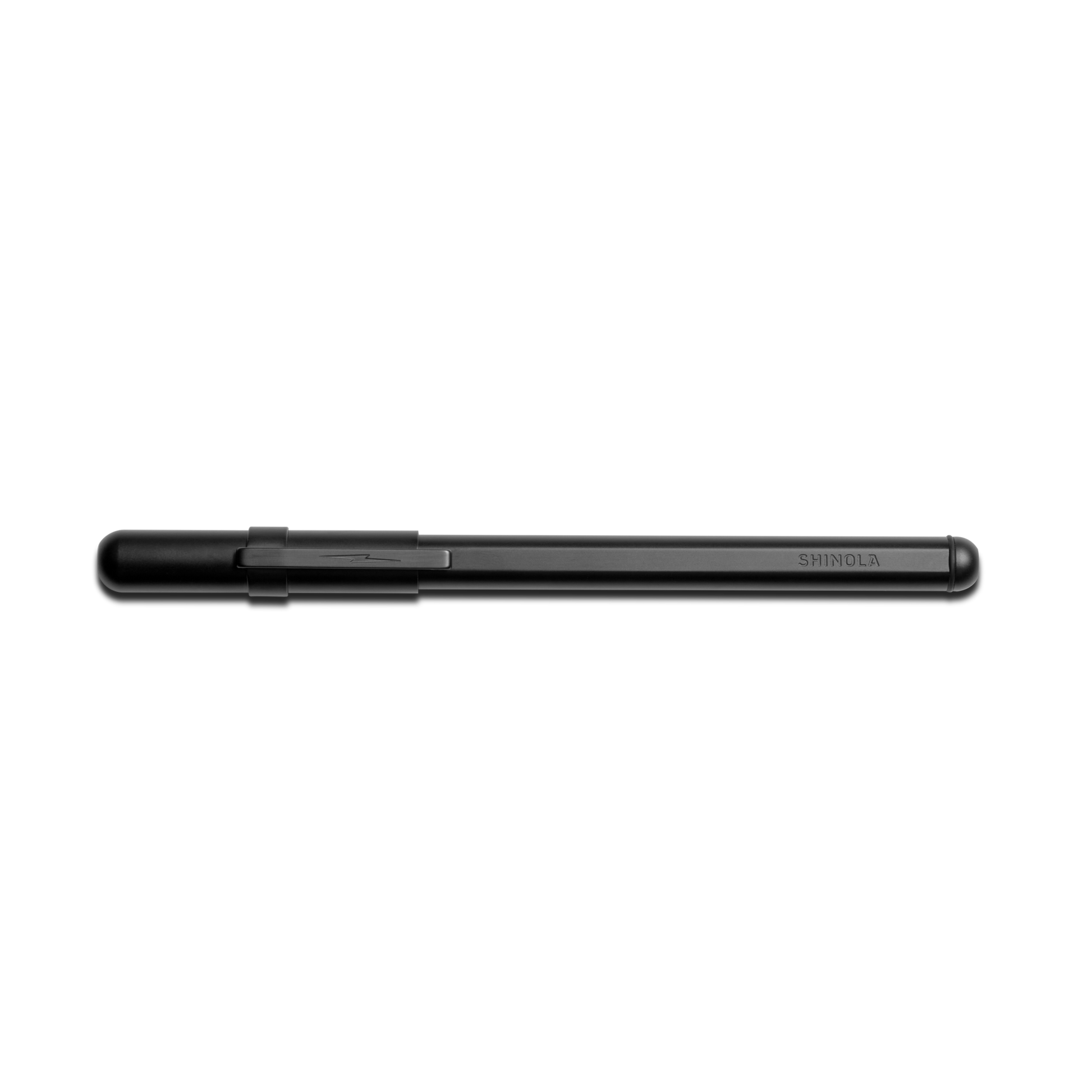 The Shinola Stainless Steel Studio Pen - Matte Black is a slim, elegant ballpoint pen with a clip, shown horizontally on a white background. "Shinola" is engraved near the cap on its sleek stainless steel body.