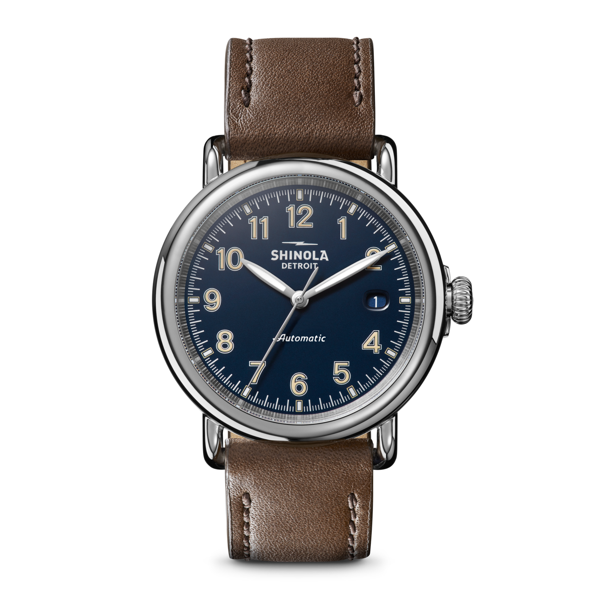 The Shinola Runwell Automatic Watch features a blue dial with silver numerals and hands, a brown leather strap, and a date window at 3 o’clock. The watch face displays "Automatic," showcasing this refined timepiece.
